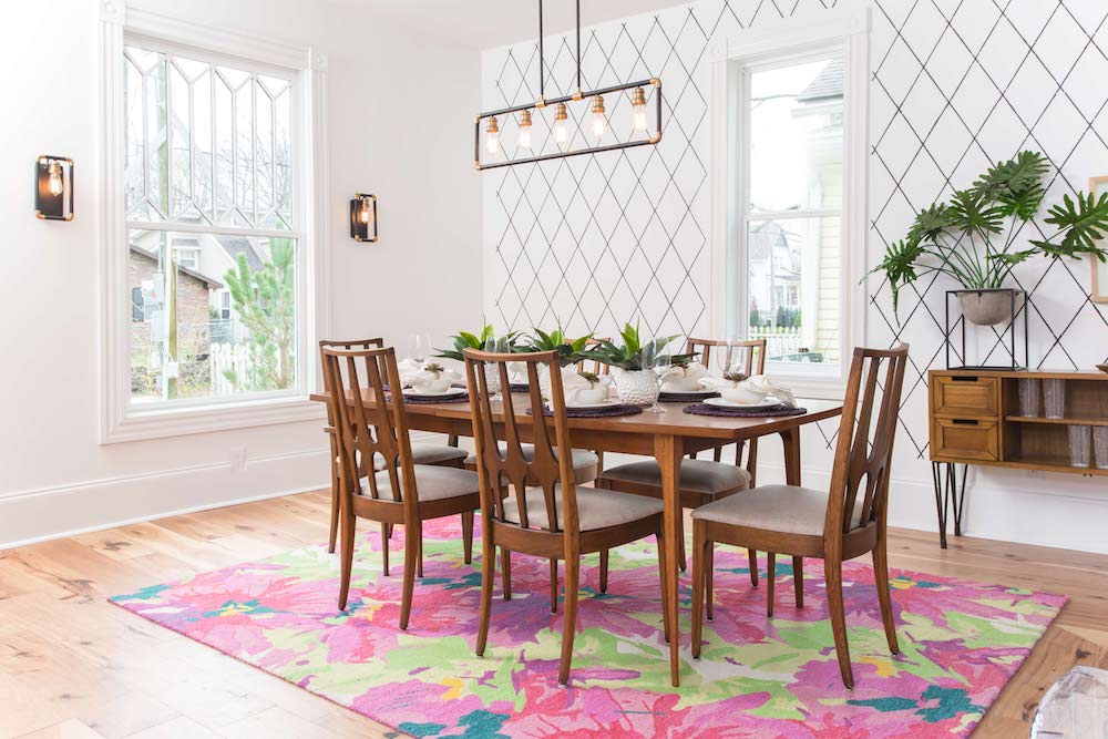 Masters of Flip bohemian Victorian house dining room vintage table and chairs sit on a large pink and green floral rug