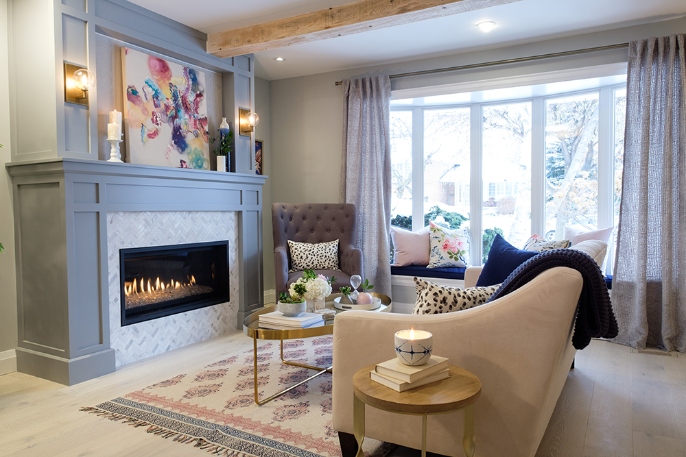 Chic living room with a gas fireplace, grey moulded feature wall and a cream coloured couch