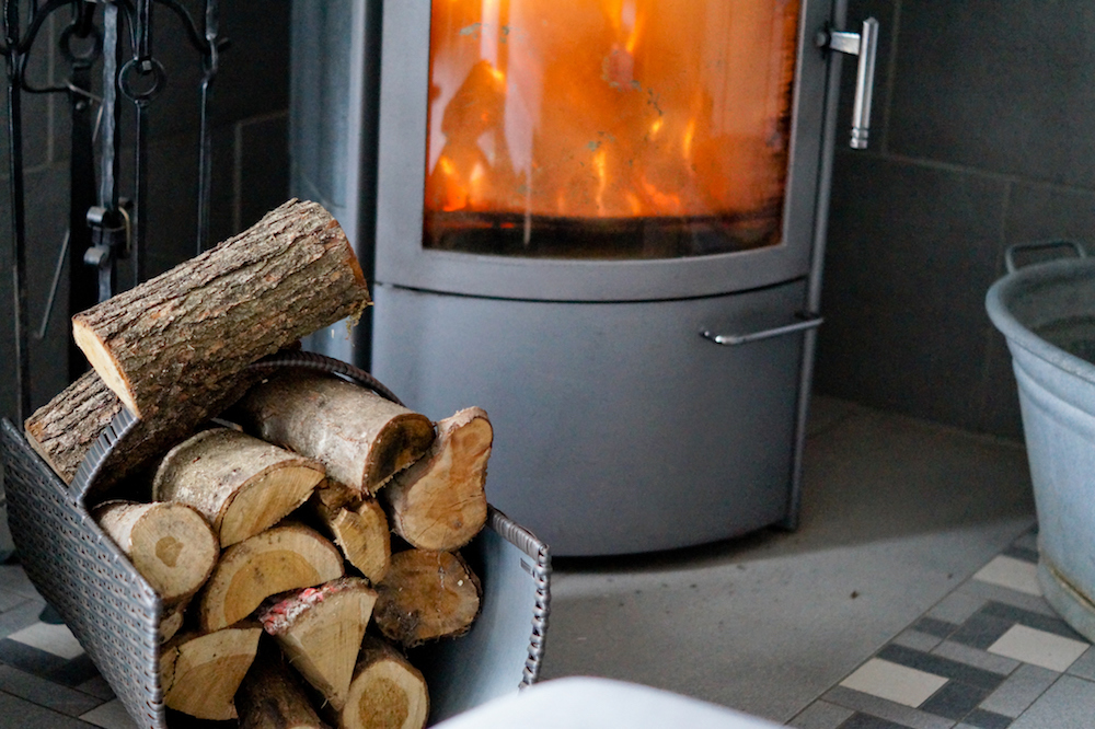 Logs on container by wood burning stove
