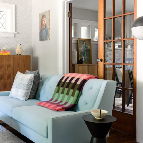 A shot of a cozy living room with a light blue sofa