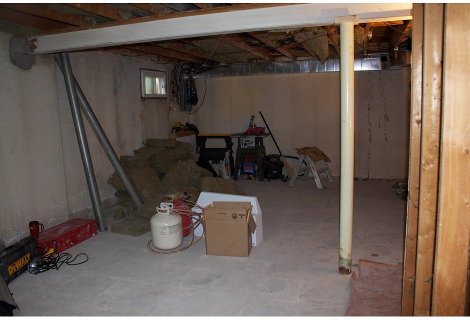 Unfinished basement filled with boxes and various odds and ends