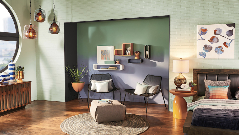 Funky loft bedroom with wood floors, a round rug with a pouf footstool, three hanging cage pendant lights, and walls painted in BEHR Mild Mint PPU11-12, Hematite N460-6, Gallery Green S400-5 and Camelot S550-4