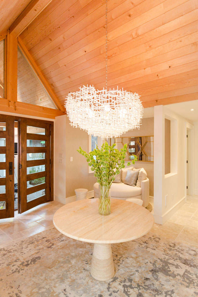 Modern luxury entryway with large statement pendant light.