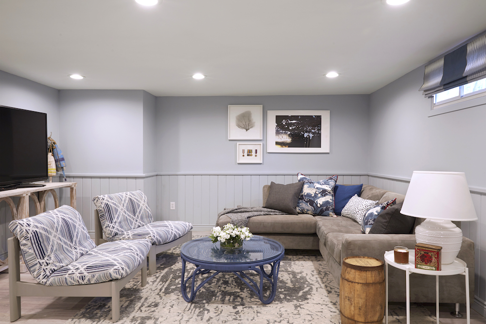 Buyers Bootcamp detached bungalow blue basement living room with grey couches, chairs and a large TV