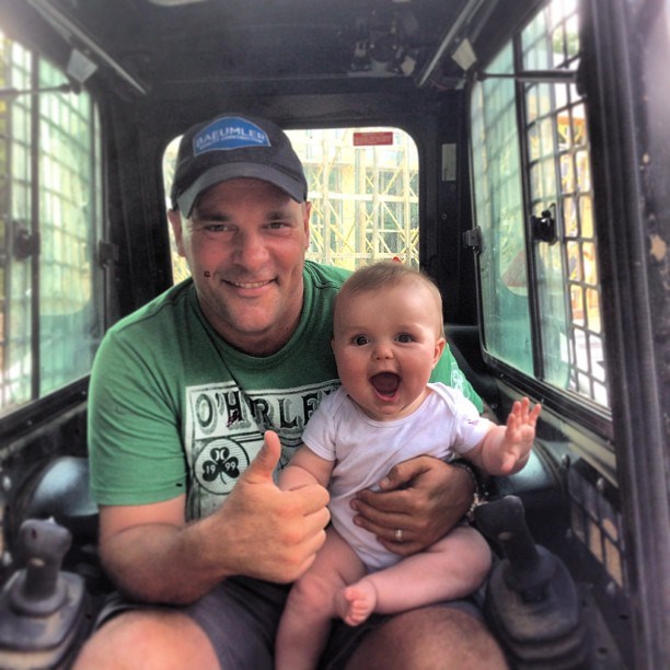 Bryan Baeumler sitting in an excavator with his daughter JoJo when she was younger.
