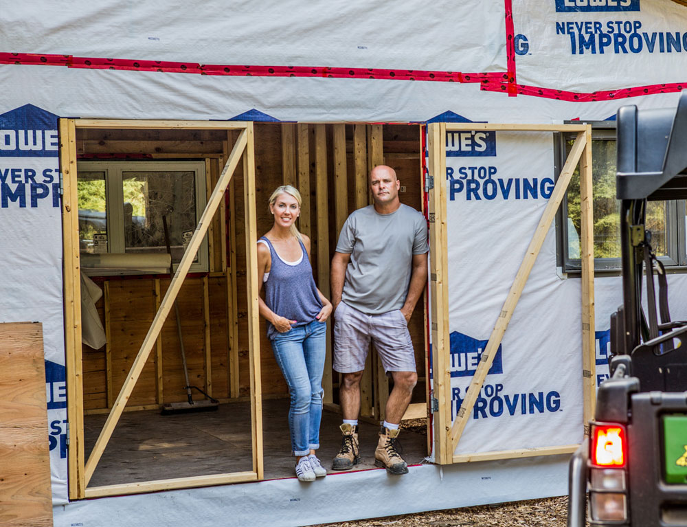 Bryan and Sarah Baeumler Standing in Barn Structure