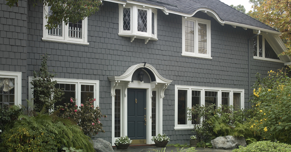 Classic cedar shingled home exterior painted dark grey with BEHR Intergalactic N450-5, white trim in BEHR Polar Bear 75, and a blue door in BEHR Deep Breath S460-7