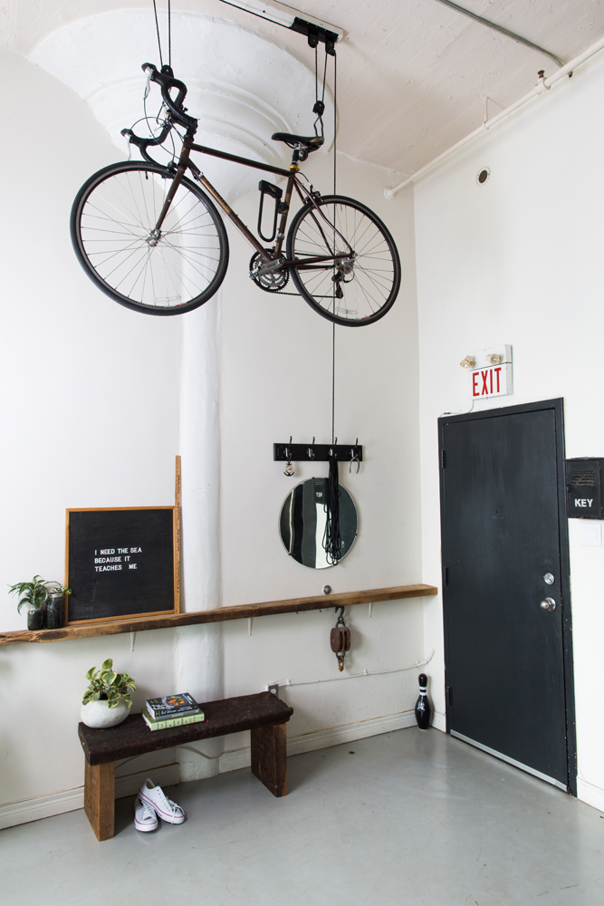 Entryway with bicycle suspended from the ceiling