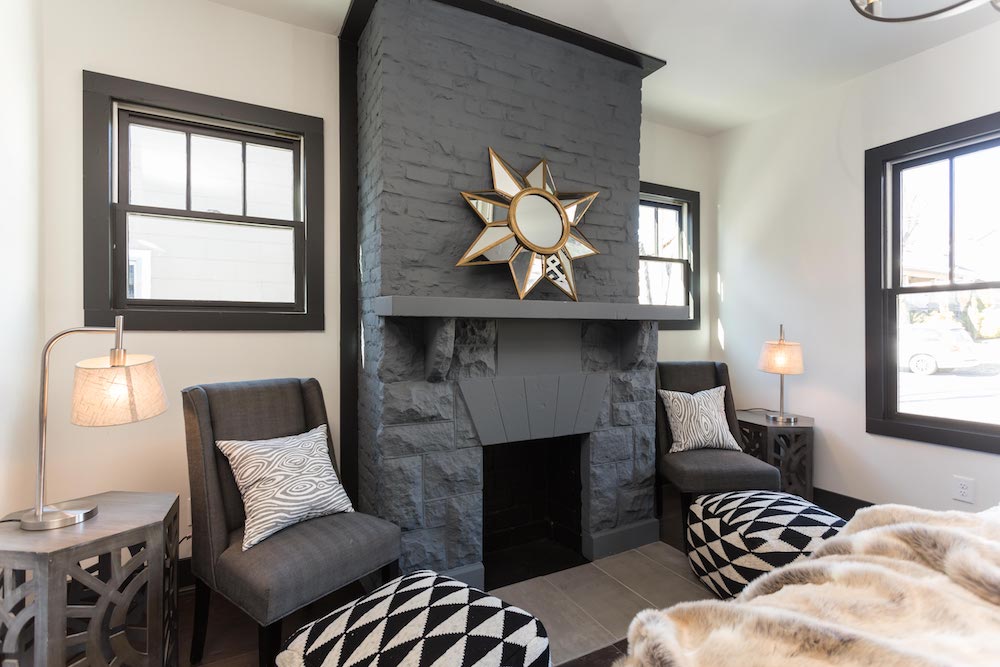 Masters of Flip luxe lodge master bedroom grey brick fireplace