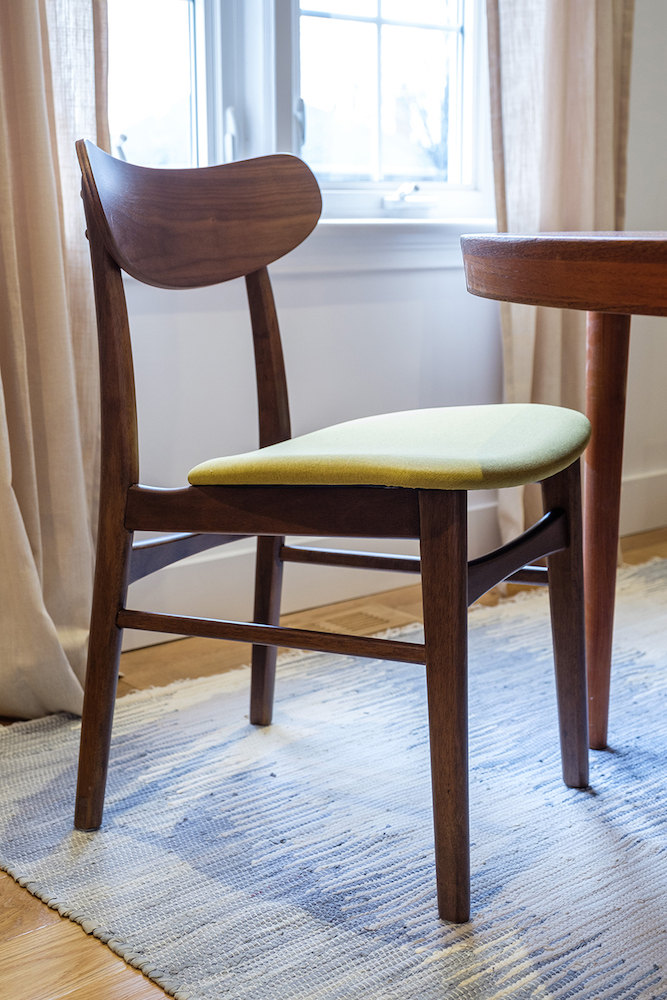 Mid century modern dining room chair on a blue rag woven rug