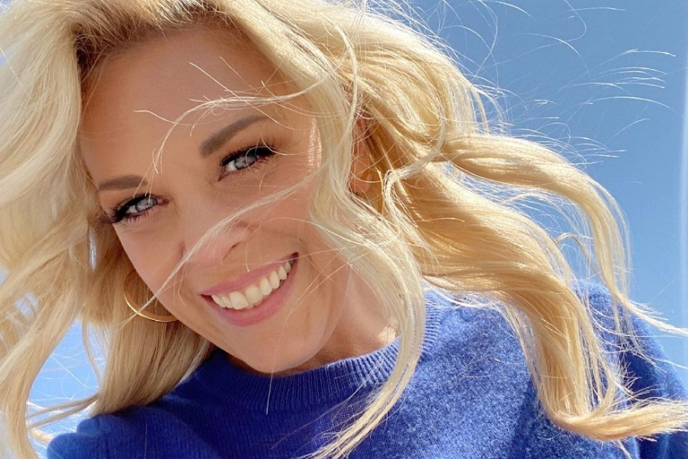 Kortney Wilson selfie smiling in a blue sweater
