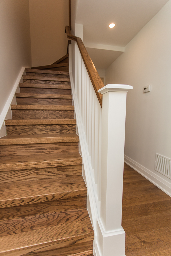 Hardwood staircase with classic white banister.