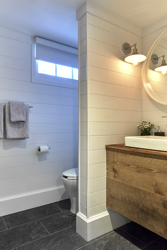 Buyers Bootcamp detached bungalow basement bathroom with white wood panel walls and raw wood vanity