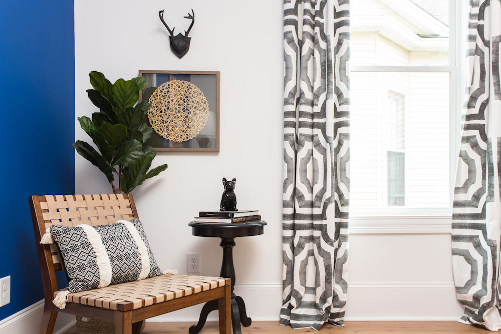 Masters of Flip bohemian Victorian house master bedroom black and white curtains, blue wall and wooden woven seat chair