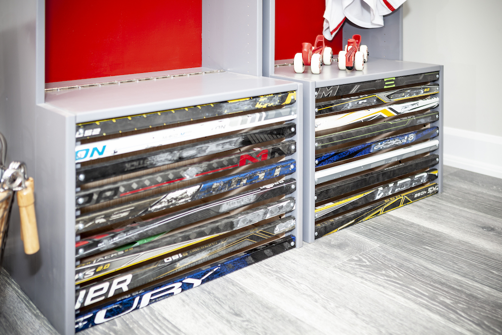Two custom made hockey lockers feature old hockey sticks and red back walls
