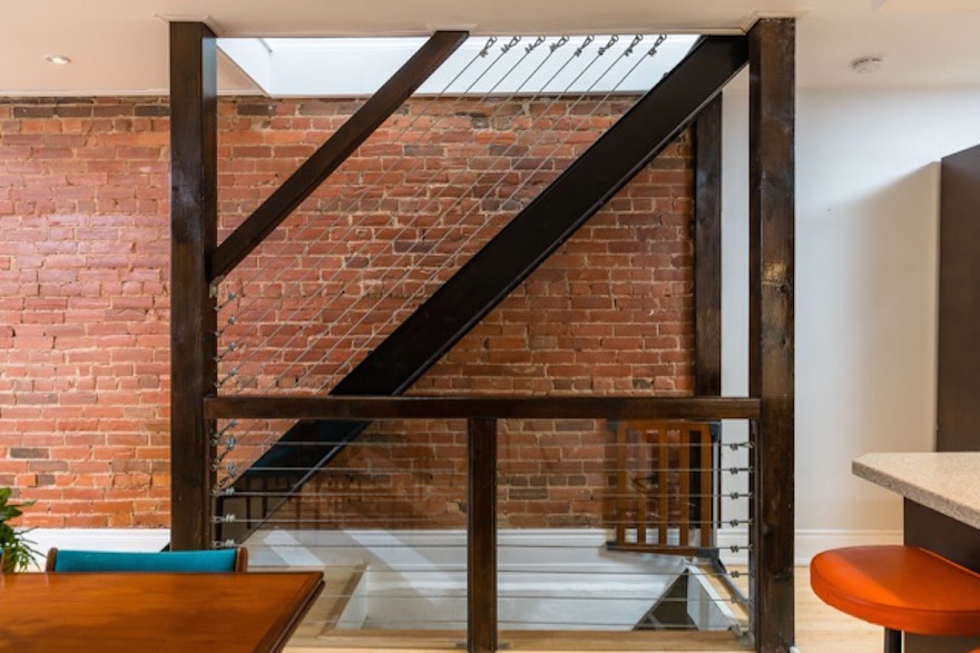 Exposed brick wall and staircase of home in Toronto's Junction Triangle
