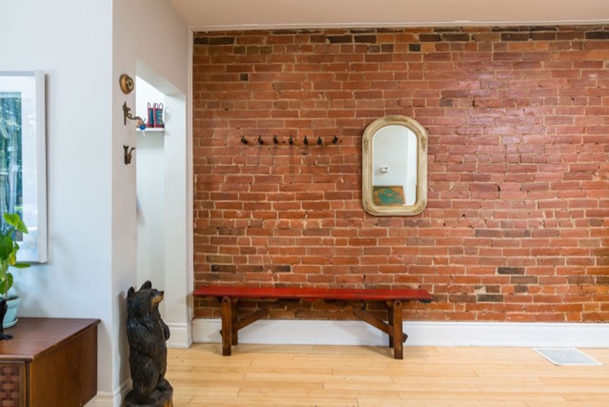 Exposed brick wall in foyer of home in Toronto's Junction Triangle