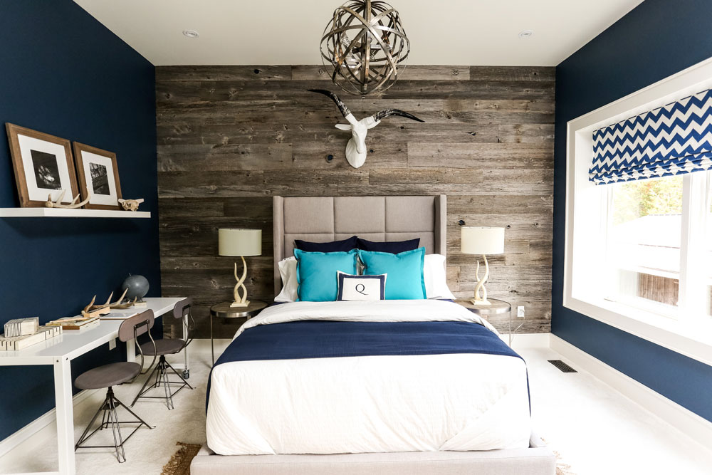 Rustic boy's bedroom design with wood-plank accent wall and hits of blue.