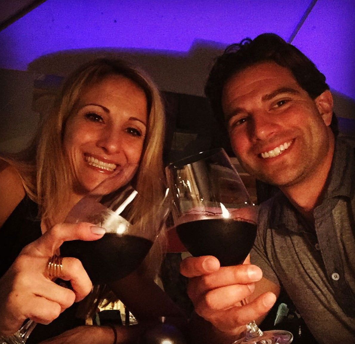 Sabrina and Scott McGillivray clinking wine glasses