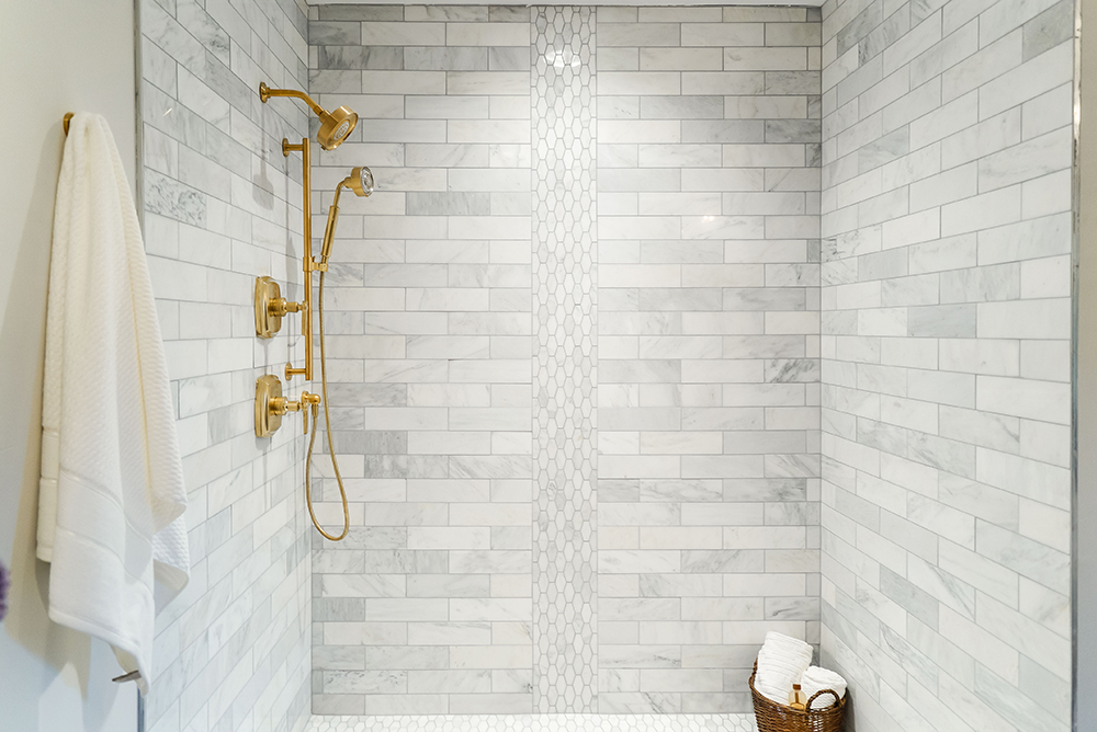 Modern white shower with gold fixtures