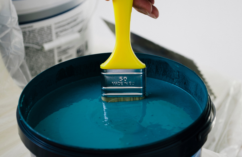 Close-up of turquoise paint in can