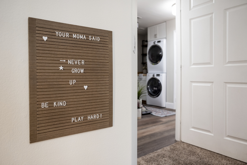 A message board outside the laundry room shares sweet sayings with family members
