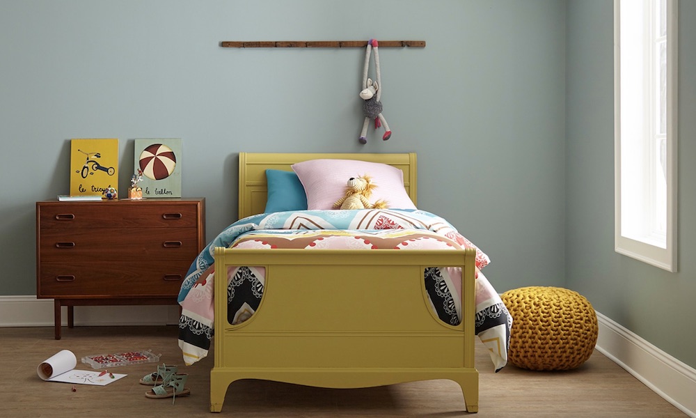 Classic mid-century modern inspired child’s bedroom with teak dresser, yellow bed and walls painted in BEHR Rainy Afternoon N430-4 and Sleek White OR-W15