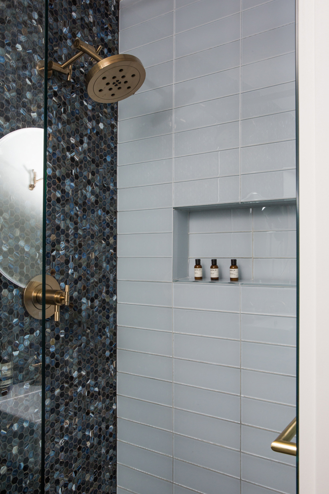 Shower with tiled niche for toiletries and brass hardware