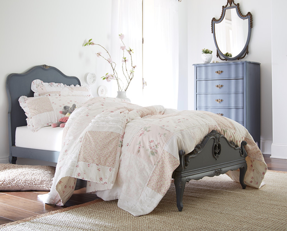 Bright bedroom with a bed painted in BEHR Chalk Decorative Paint Onyx Gray BCP44 and a dresser in BEHR Memory Lane BCP34