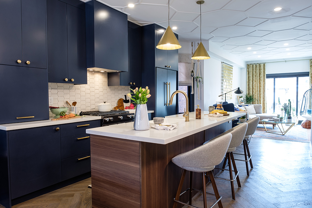Mid century modern inspired kitchen with blue cabinets and a large wood centre island
