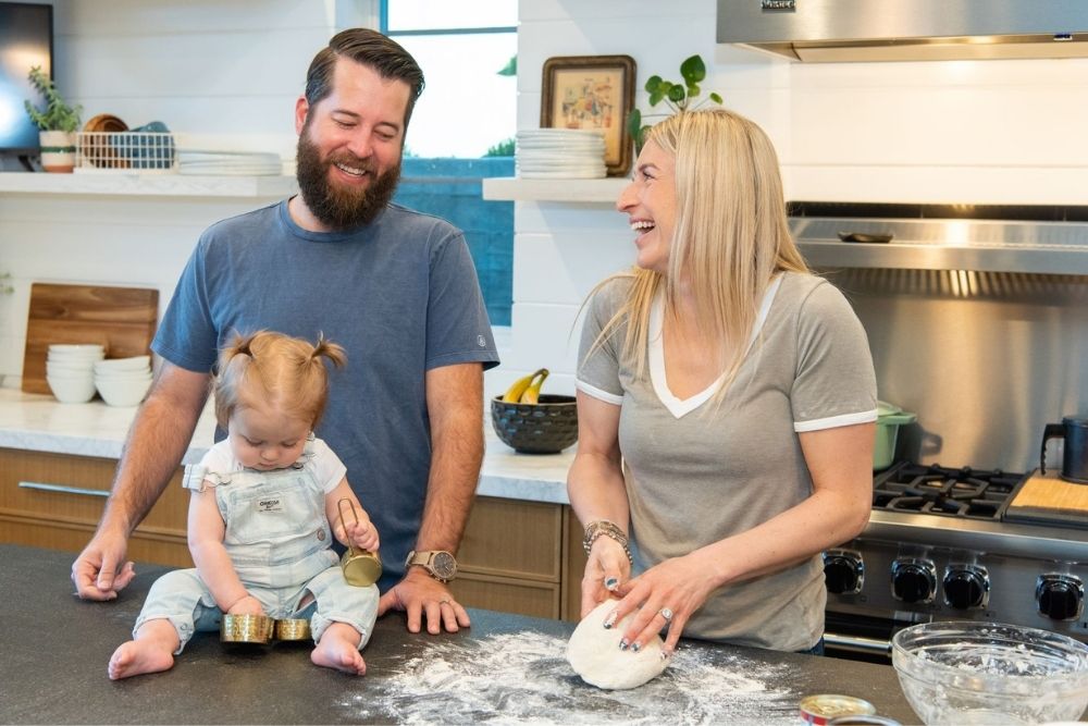 Jasmine making homemade pizza with her husband Brett and baby Hazel