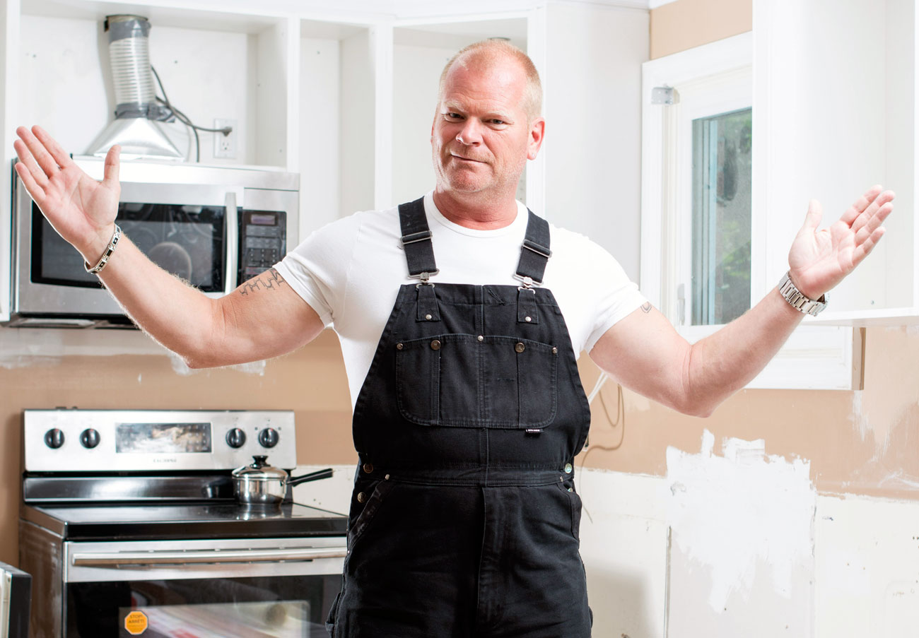 Mike Holmes standing in a kitchen that is in the middle of renvoations
