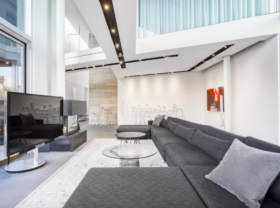 Gray-hued condo living room with high ceilings