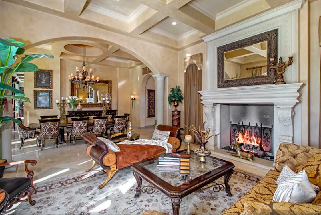 Interior that includes spacious kitchen table and giant fireplace