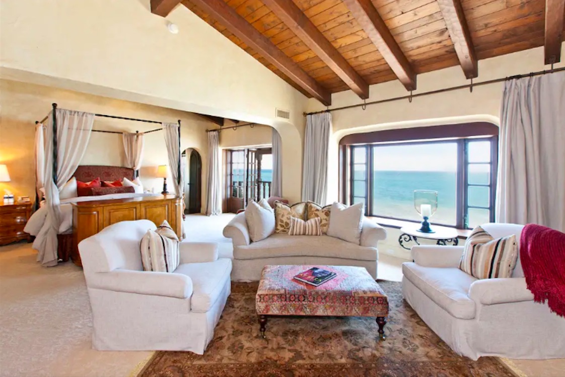 A private master bedroom with office, fireplace and sitting room that faces the water