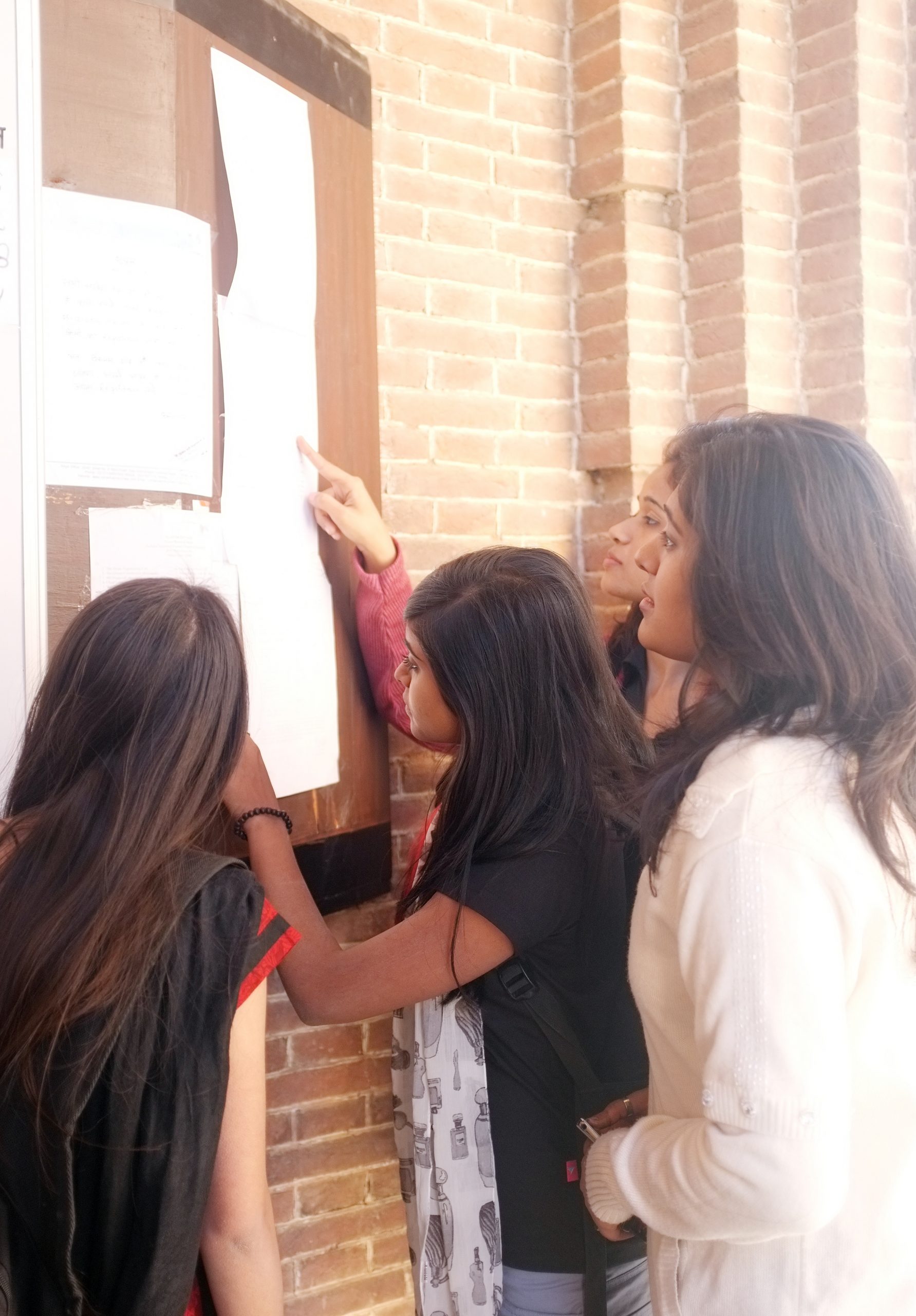 Women looking at community listing board