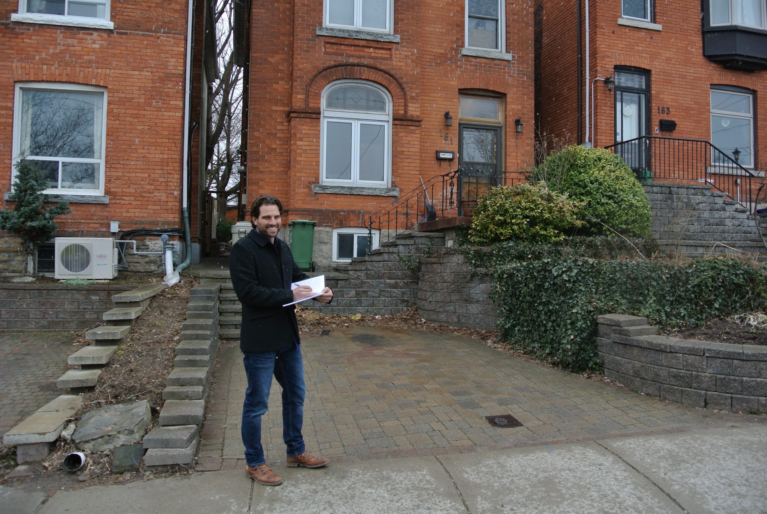 Scott McGillivray in front of brick house