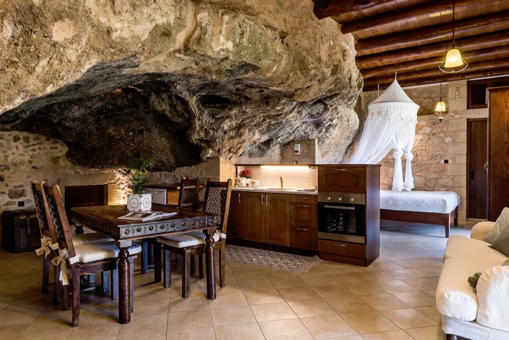 wooden furniture inside stone kitchen inside cave
