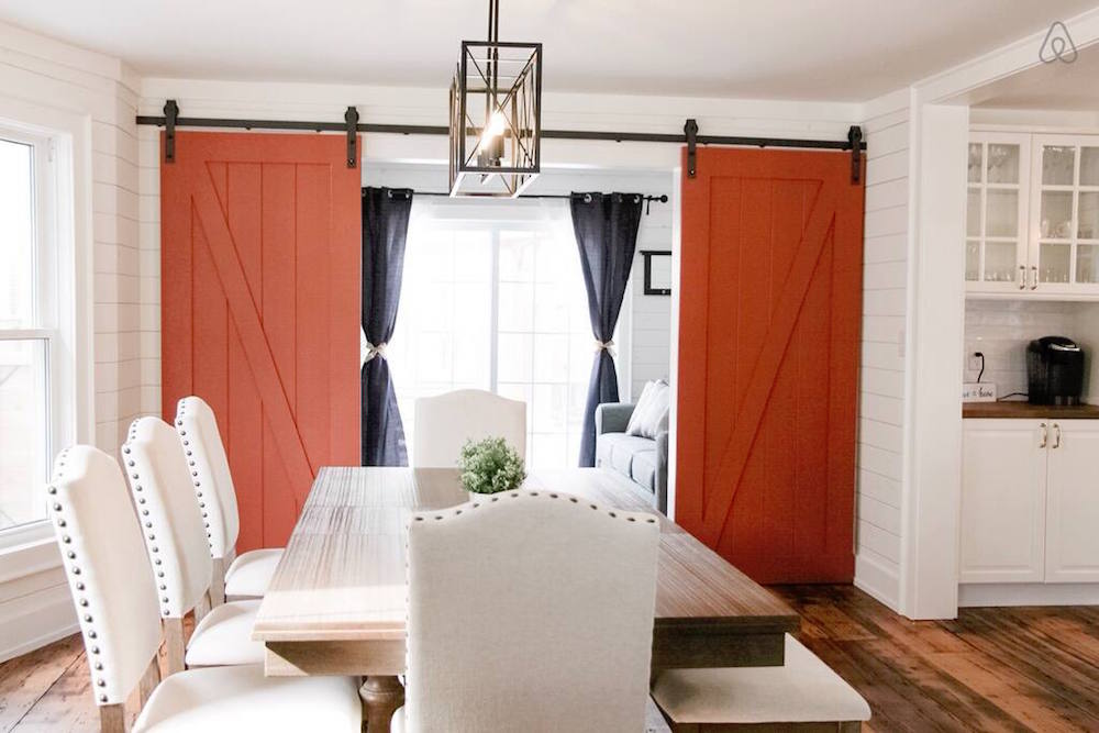 white dining room with red barn doors