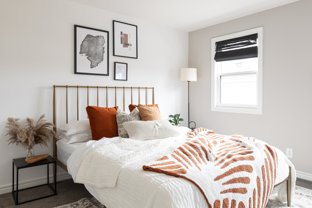 Guest bedroom with orange throw