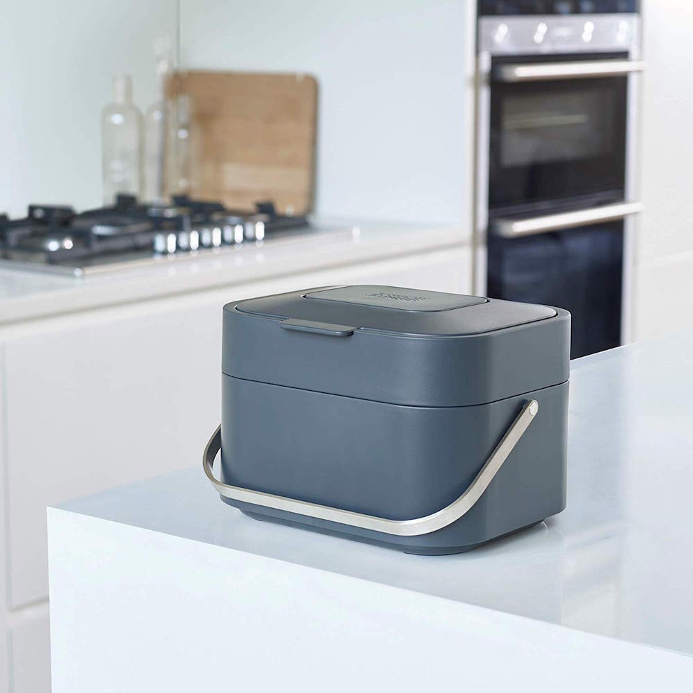 grey compost bin on counter in modern white kitchen