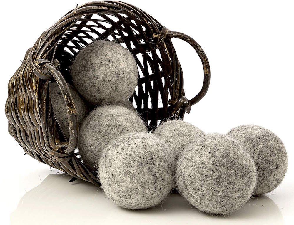 brown basket tipped on side with grey wool dryer balls spilling out