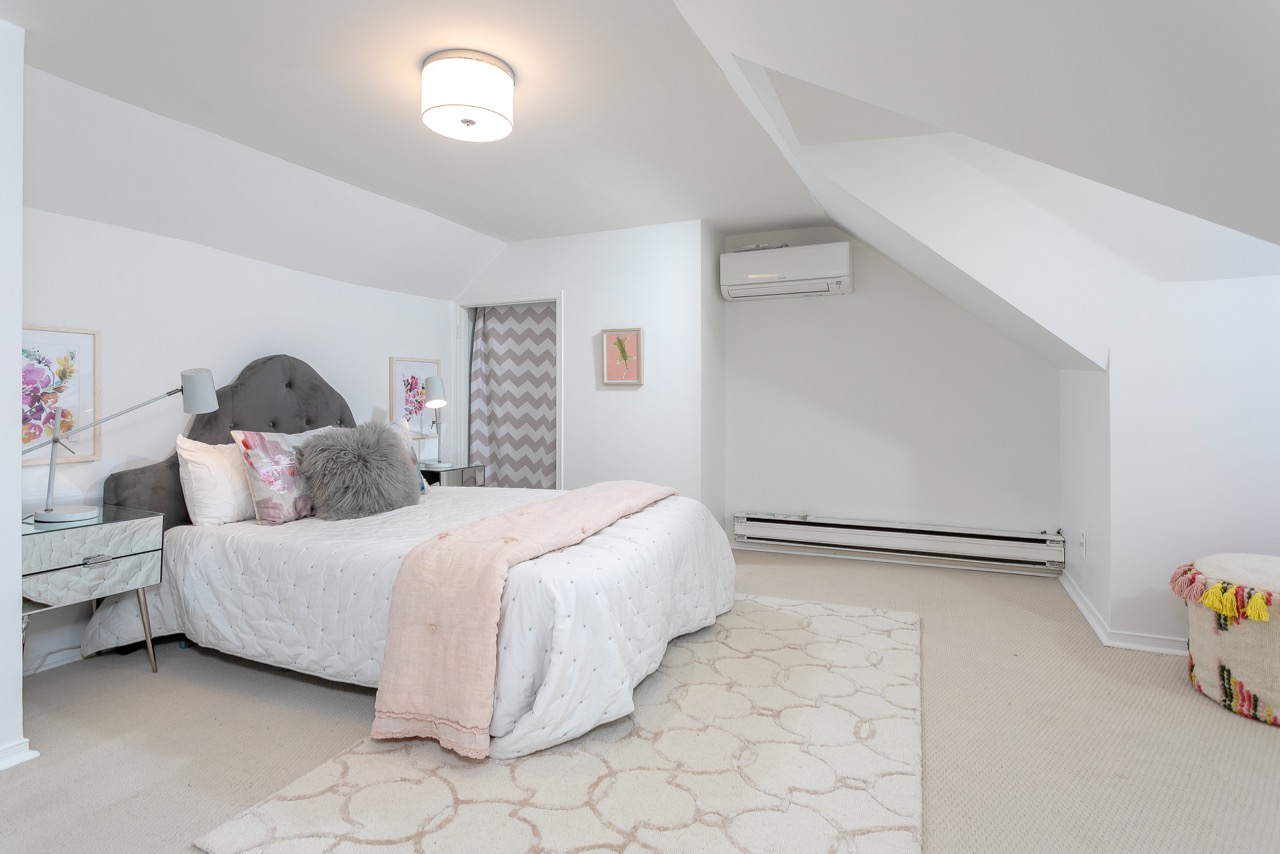 Attic bedroom with pale pink and grey accents