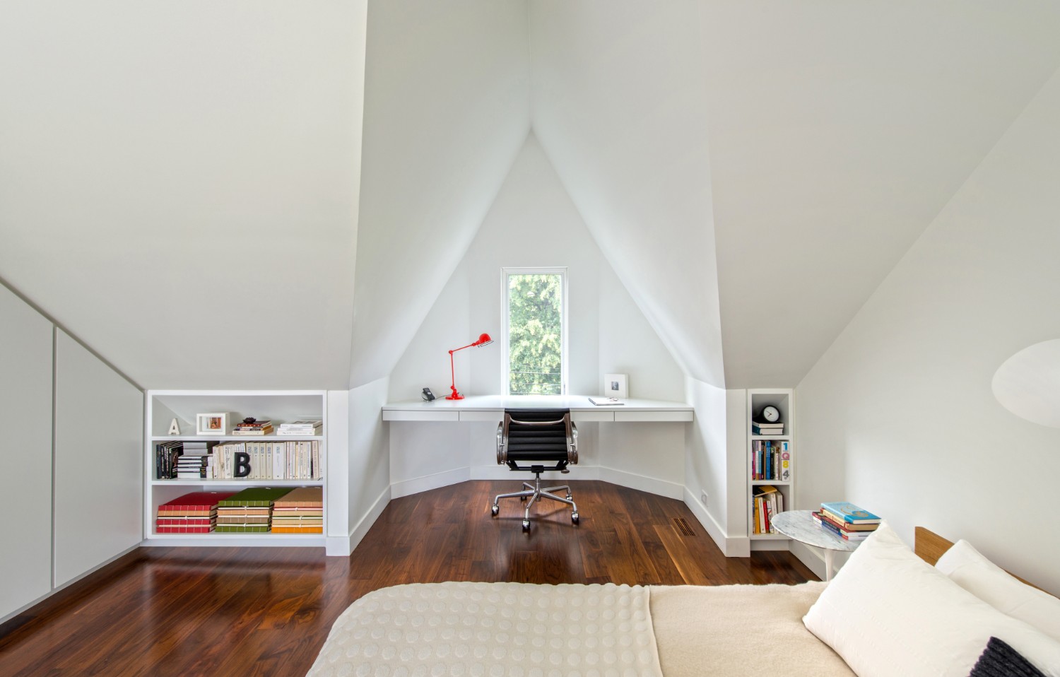 Attic with workspace, shelves and bed