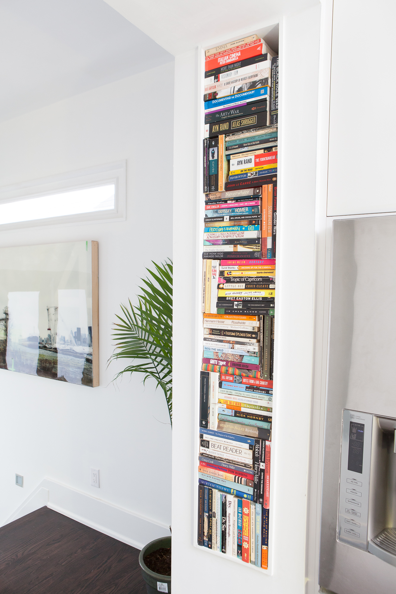 Integrated wall niche in kitchen to display books.