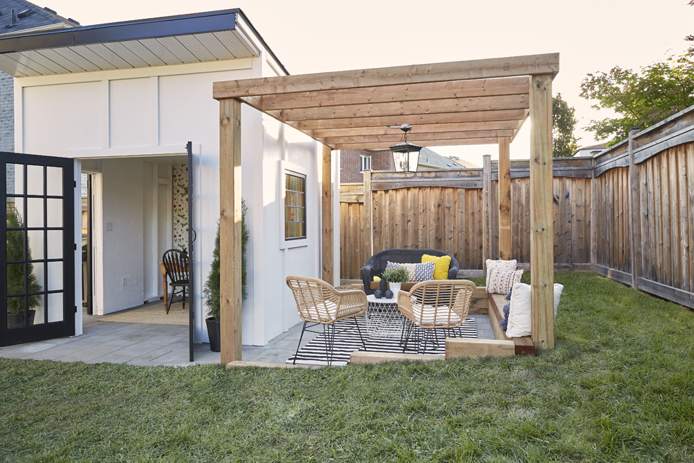 Simple wood pergola next to a renovated backyard shed