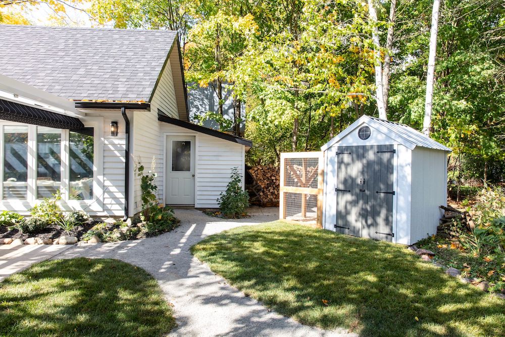 exterior of converted white garage and chicken coop shed