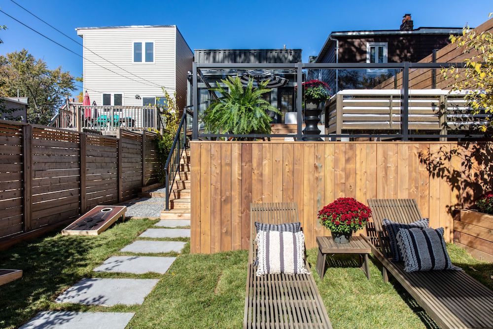 backyard with wooden deck and glass railings in background