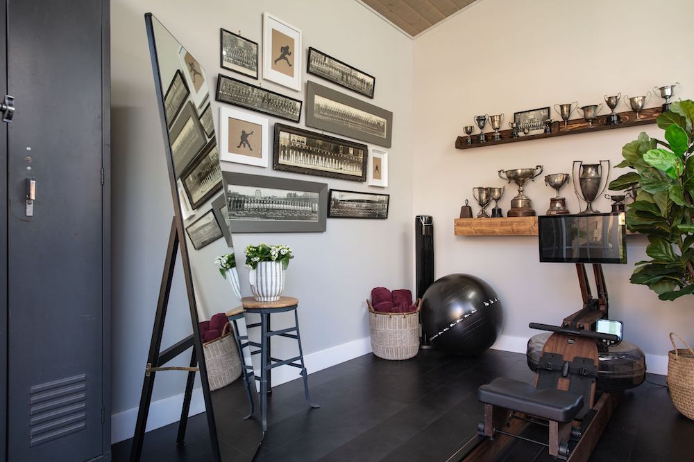 home gym interior with vintage trophies and gallery wall