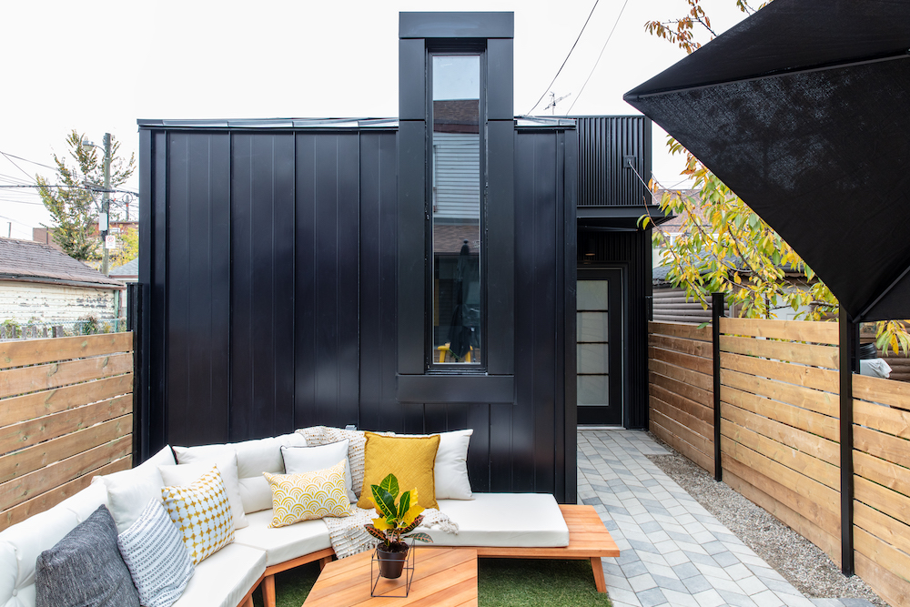 backyard with black building and outdoor sectional